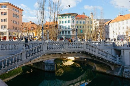 Ljubljana, Slovenia - January 14, 2019: Triple Bridge above Ljubljanica River in Ljubljana old town street, Slovenia. Beautiful Slovenian capital green city. Tromostovje bridge at Preseren Square.のeditorial素材