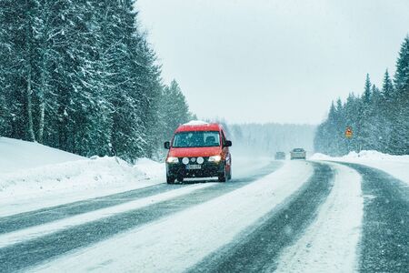 Rovaniemi, Finland - March 1, 2017: Mini van in the Snowy Winter Road in Finland in Lapland.のeditorial素材