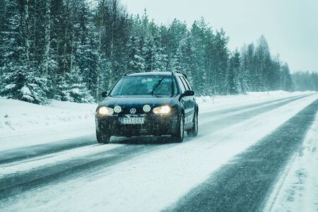 Rovaniemi, Finland - March 1, 2017: Car in the road at snowy winter Lapland, Rovaniemi, Finlandのeditorial素材
