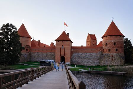 Trakai, Lithuania - August 4, 2018: People at Trakai Castle on the Galve Lake in Trakai in Lithuania in the evening.のeditorial素材