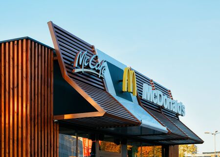Vilnius, Lithuania - October 6, 2018: Mcdonald and Mccafe logo at the roof of the restaurant.のeditorial素材