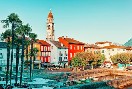 Ascona, Switzerland - August 23, 2016: Boats in Ascona luxury tourist resort promenade in Lake Maggiore in Ticino canton in Switzerland in summer. People outdoor street travel. Romantic Swiss holidayのeditorial素材