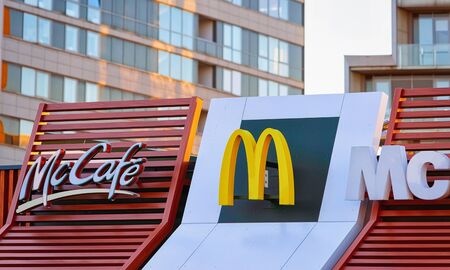 Vilnius, Lithuania - October 6, 2018: Mcdonald and Mccafe logo on the roof of the restaurant.のeditorial素材