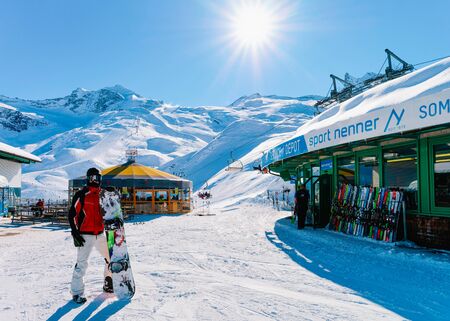 Hintertux, Austria - February 5, 2019: Man with snowboard at Hintertux Glacier ski resort in Zillertal in Tyrol in Austria in winter in Alps. Snowboarder at Alpine mountains with snow.のeditorial素材