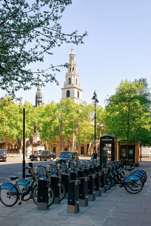 London, UK - May 2, 2011: Parking of bicycles for rent on Strand in London city in the UK. Street architecture. View on Old town, England in spring in day time.のeditorial素材