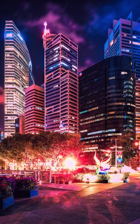 Singapore, Singapore - March 1, 2016: Skyline of Downtown Core on the embankment of Marina Bay in Singapore at night. Cityscape of Skyscrapers.のeditorial素材