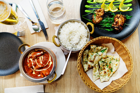 Naan bread, tikka masala chicken and rice as Indian food cuisine in a restaurant in Ljubljana in...