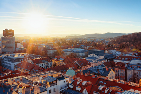 Beautiful sunset at Ljubljana old town and business downtown center, Slovenia. Skyline of European city with Alps mountains. Evening view with scenery and streets landscape. Winter cityscapeの写真素材