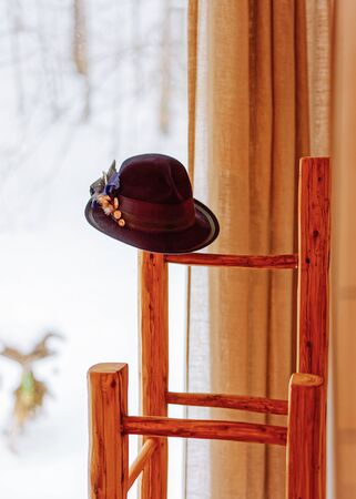 Hanger with hat at window. Detail of Interior of contemporary living room of modern apartment house. Home and landscape. Deocr. Rustic, vintage styleの写真素材