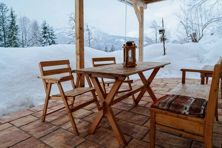 Terrace with table and chairs at House architecture at Bad Goisern village near Hallstatt in Upper Austria. Townhouse real estate and residential building.の写真素材