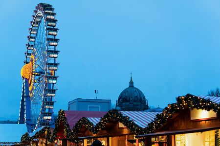 Christmas market with Ferris Wheel in Germany in Europe in winter. German Night street Xmas and holiday fair in European city or town. On Berliner Rathausの写真素材