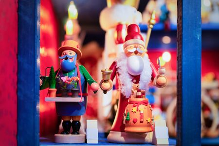 Wooden Christmas tree toys and Santa Claus in Christmas market in Germany in Europe in winter. German Night street Xmas and holiday decorations fair in European city or town. Berlin in Gendarmenmarktの写真素材