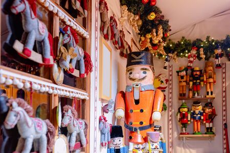 Wooden Christmas toys and decorations at Christmas market at Germany in Europe in winter. German street Xmas fair with wood nutcrackers in European city or town. Berlin in Alexanderplatzの写真素材