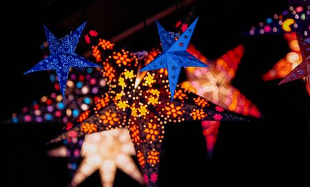 Star as Christmas tree decorations in Christmas market in Germany in Europe in winter. German Night...