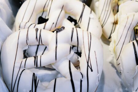 Glazed Bretzel in Christmas market in Germany in Europe in winter. German Night street Xmas and holiday fair in European city or town, December. Kaiser Wilhelm Memorial Church, Berlinの写真素材