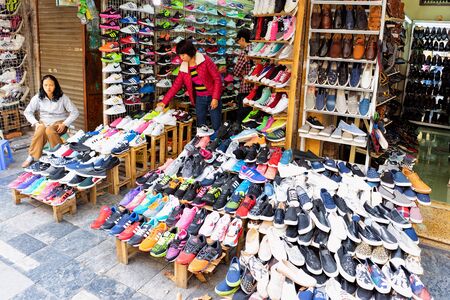 Hanoi, Vietnam - February 21, 2016: Vendors at street market selling sports shoes and sneakers in old city of Hanoi in Southeast Asia in Vietnam. Local business of traders and traditional shop.のeditorial素材