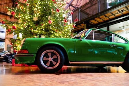 Berlin, Germany - December 11, 2017: Green vintage classic Porsche car in Berlin in Germany. Details of auto. Christmas tree on the backgroundのeditorial素材