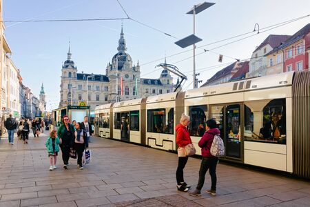 Graz, Austria - February 16, 2019: People and tram on Hauptplatz and Town Hall square in Old city of Graz in Austria. Styria in Europe.