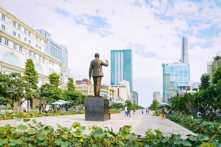 Ho Chi Minh, Vietnam - February 26, 2016: Square at Ho Chi Minh city Hall with Statue in Ho Chi Minh city in Vietnam in Asia. Former Vietnamese town called Saigon. Cityscape with park and businessのeditorial素材