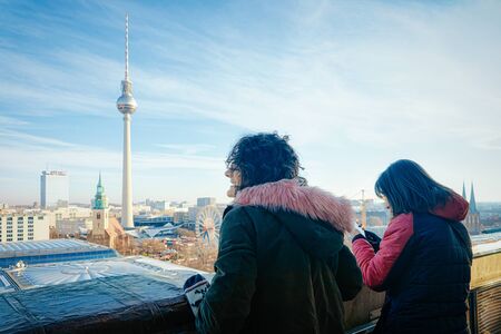 Berlin, Germany - December 12, 2017: Gilrs looking at panoramic view on German City centre in Berlin...