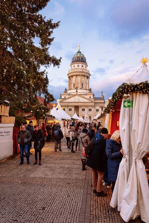 Berlin, Germany - December 8, 2017: People at Stalls on Evening Christmas market on Gendarmenmarkt in Berlin in Germany in Europe in winter. German Night street Xmas and holiday fairのeditorial素材