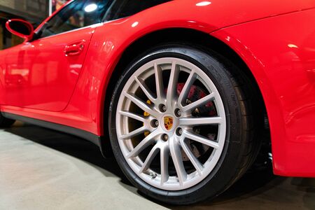 Berlin, Germany - December 11, 2017: Wheel of red vintage classic Porsche car in Berlin of Germany....