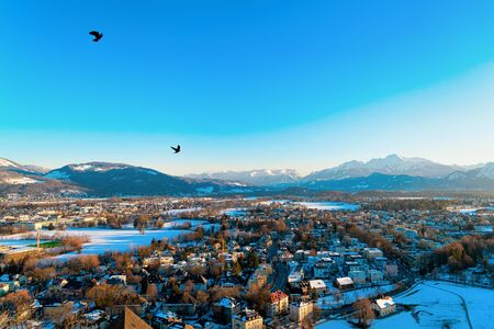 Panorama of Salzburg with snow from Monchsberg hill in Austria. Landscape and cityscape of Mozart...