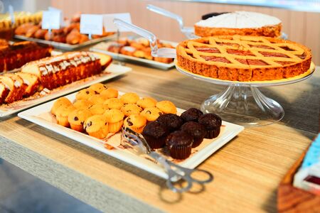 Sweet muffin pastry with chocolate in cafe and bakery. Puff mini cupcakes at patisserie. Cakes and...