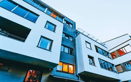 Detail of Modern residential apartment with flat building exterior. Fragment of New luxury house and home complex. Part of City Real estate property and condo architecture. Copy space. Blue skyの写真素材