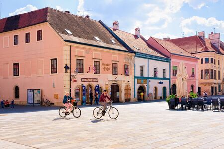 Couple on bicycles at Street cafes at Town Hall Varazdin