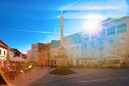 People at street cafes on Castle Square in Maribor