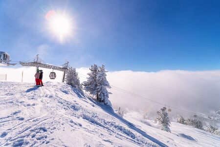 Sun flares and Red Cable cars in Zillertal Arena ski resort in Tyrol in Mayrhofen in Austria in...
