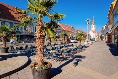 Main square with Palms trees at street cafe and Saint James Catholic Church in town Leibnitz in Styria in Austria. Cathedral architecture.の写真素材