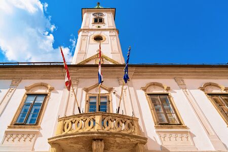 Tower of Town Hall with flags in Old city of Varazdin in Croatia. Panorama and Cityscape of famous Croatian town in Europe in summer. Travel and tourism for tourists.の写真素材