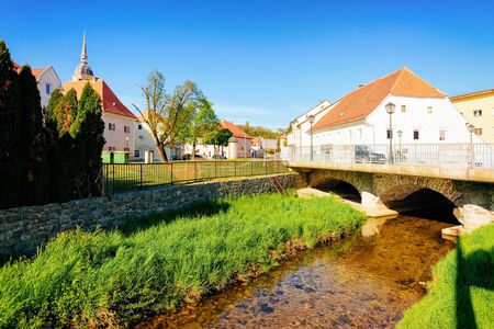 Landscape with bridge over Bistrica River and Saint Bartholomew Church in Old Slovenska Bistrica near Maribor in Slovenia. City travel in South Styria in Slovenija. Scenery in Slovenian town.の写真素材