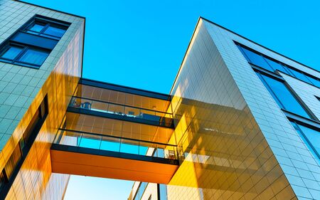 Apartment in residential building exterior. Housing structure at blue modern house of Europe. Rental home in city district on summer. Wall and glass high architecture for business property investment.の写真素材