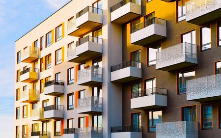 Apartment in residential building exterior. Housing structure at blue modern house of Europe. Rental home in city district on summer. Architecture for business property investment, Vilnius, Lithuania.の写真素材