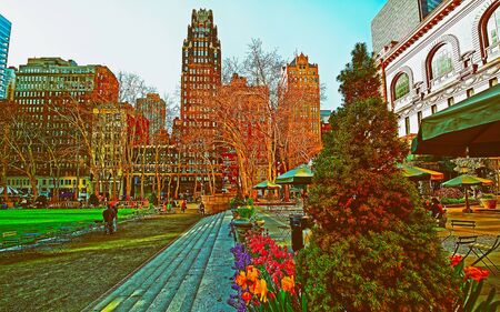 Tourists looking at Green Lawn in Bryant Park in Midtown Manhattan, New York, USA. United States of America. NYC, US. Skyline with skyscrapers and American cityscape.の写真素材