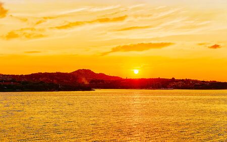 Scenery with Porto Rotondo at sunrise or sunset on the Mediterranean Sea. Porto Cervo in Sardinia Island in Italy in summer. Landscape on Sardegna. Sardinian Olbia province. Mixed media.の写真素材