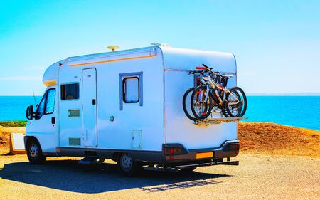 Camper with bicycles at Capo Pecora resort Mediterranean sea Sardinia reflexの写真素材