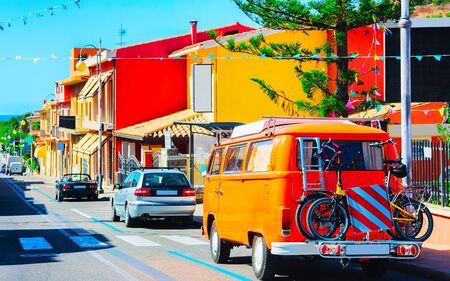 Old van with bicycles on road in Villasimius Cagliary Sardinia reflexの写真素材