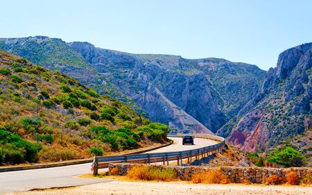 Scenery with car at highway in Cagliari in Sardinia hills reflexの写真素材