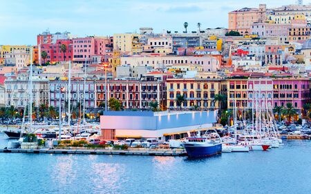 Old Sardinian Port with ships at Mediterranean Sea and city of Cagliari, South Sardinia Island in Italy in summer. Cityscape with marina and Yachts and boats in townの写真素材