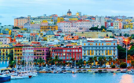 Old Sardinian Port with ships at Mediterranean Sea and city of Cagliari, South Sardinia Island in Italy in summer. Cityscape with marina and Yachts and boats in townの写真素材