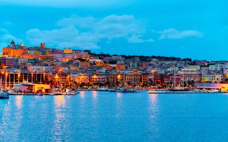 Old Sardinian Port with ships at Mediterranean Sea and city of Cagliari, South Sardinia Island in Italy in summer. Cityscape with marina and Yachts and boats in townの写真素材