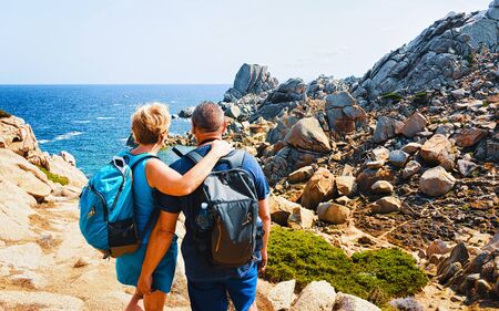 Family and Landscape with Rocky coast of Capo Testa in Santa Teresa Gallura at the Mediterranean Sea on Sardinia Island in Summer Italy. Couple and Scenery of Cagliari province. Mixed media.の写真素材