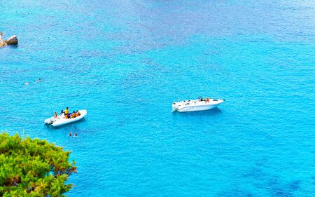 Boats in blue Mediterranian Sea in Capo Testa reflexの写真素材