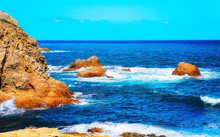 Coast of Capo Pecora beach at Mediterranean sea Sardinia reflex