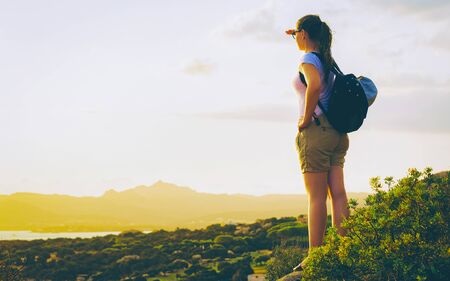 Young girl looking sunrise at Costa Smeralda resort Mediterranean reflexの写真素材