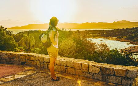 Young girl looking sunrise in Capo Ferroの写真素材
